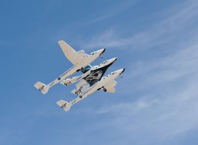 Virgin Galactic file photo of the VSS Enterprise being carried by its mothership VMS Eve over Spaceport America in New Mexico.