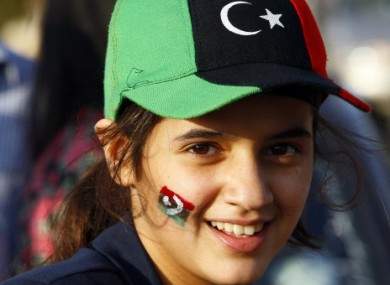 A Libyan girl dons the colours of the new Libyan flag ahead of today's declaration of liberation.