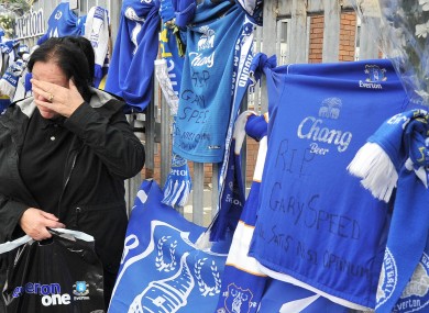 An Everton fan pays her final respects to Speed.