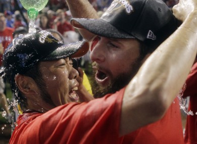 Texas Rangers' Koji Uehara of Japan and Scott Feldman celebrate in 2011.