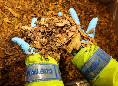 A Customs official shows tobacco seized during a raid last year. Retail Ireland believes illegal tobacco sales are costing the State over €500 million a year.