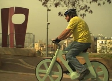 Izhar Gafni pedalling his bike made from recycled cardboard.