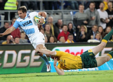Argentina's Gonzalo Comacho, left, is tackled by Australia's Pat McCabe.