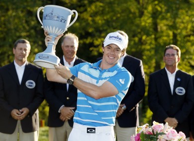 Rory McIlroy, of Northern Ireland, holds the trophy after winning the Deutsche Bank Championship.