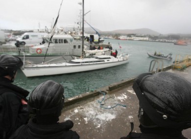 Armed naval officers guard the 'Dances with Waves' yacht which was seized off the west coast five years ago.