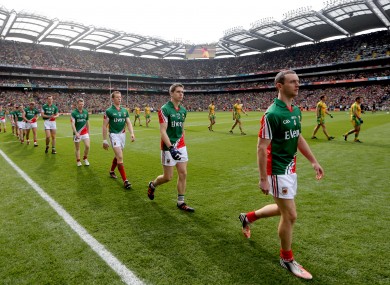 The teams parade before the game yesterday.