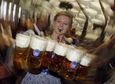 A waitress carries beer mugs in the Hofbraeuhaus tent.