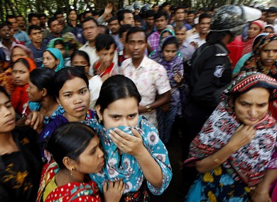 Outside the fire-shattered garment factory in Dhaka, Bangladesh where over 100 people died at the weekend.