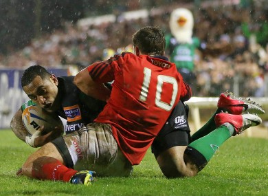 Ian Keatley tackles Fetu'u Vainikolo.