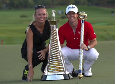 Rory McIlroy of Northern Ireland, right, holds the trophy with his girlfriend and Tennis player Caroline Wozniacki of Denmark after he wins the final round of DP World Golf Championship in Dubai last month.
