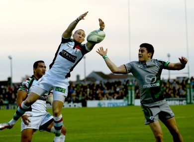 Mike Brown of Herlequins and Tiernan O'Halloran compete for a bouncing ball.
