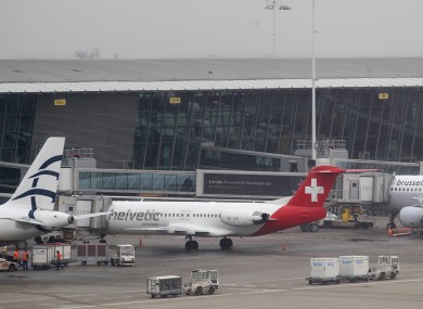 Baggage carts make their way past a Helvetic Airways aircraft from which millions' of dollars worth of diamonds were stolen on the tarmac of Brussels international airport.