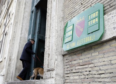 A man arrives to vote in a polling station in downtown Rome this morning.