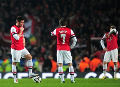 Arsenal's Tomas Rosicky (centre) and Olivier Giroud (left) stand dejeced as they wait to restart the game after conceding their third goal.