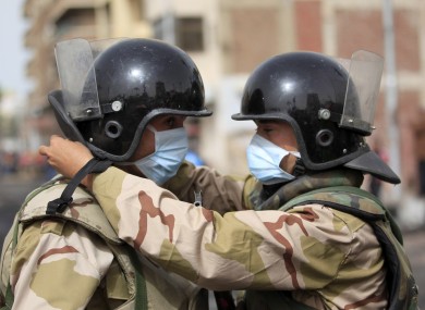 Army soldiers in Egypt prepare their masks yesterday after several days of clashes between protesters and riot police in Port Said.