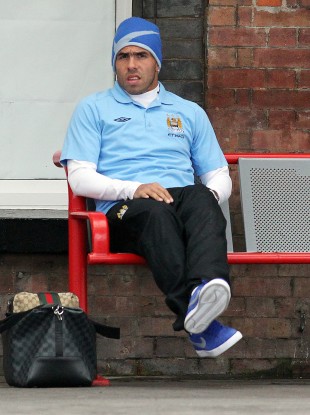 Carlos Tevez waits for a departure at Stockport Train Station.