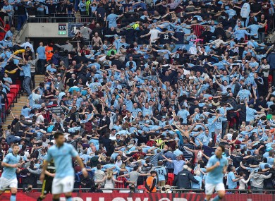 Manchester City's fans celebrate the opening goal by doing the Poznan.