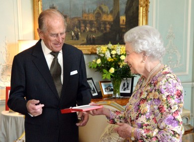 Prince Philip accepts the Order of New Zealand from his wife, Queen Elizabeth, at Buckingham Palace earlier today.