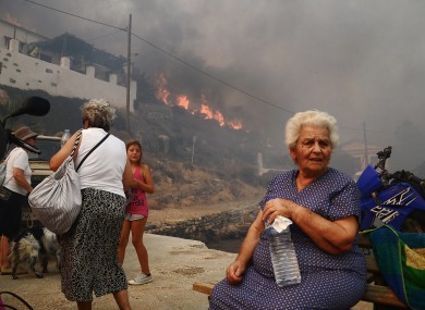 Inhabitants and holidaymakers evacuate the village of Megalo Livadi on Greece's Aegean island of Serifos