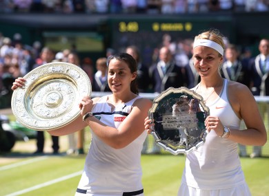 Marion Bartoli (left) poses with her trophy beside Sabine Lisicki, who shows off the runners-up plate.