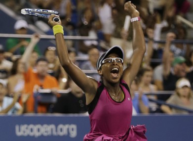 Victoria Duval, of the United States, raises her arms in celebration after defeating Australia's Samantha Stosur.