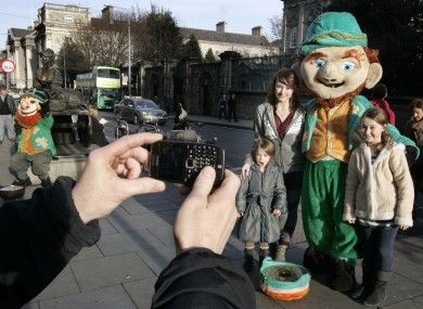 Ella Robins (4), Ava (8) and Leah (14) from Cork posing with a leprechaun near Trinity College Dublin.