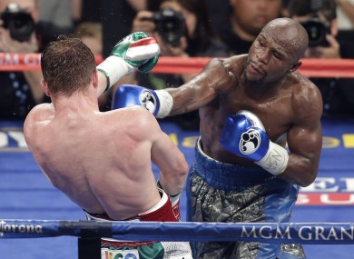 Floyd Mayweather Jr throws a punch against Canelo Alvarez during the 152-pound title fight.