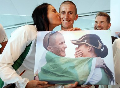 Marian Heffernan plants a kiss on husband Rob's cheek at his Dublin Airport homecoming.