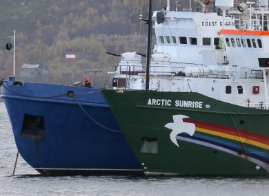 Russian coast guard boat, left, and the Greenpeace ship 'Arctic Sunrise', right, anchored next to it.