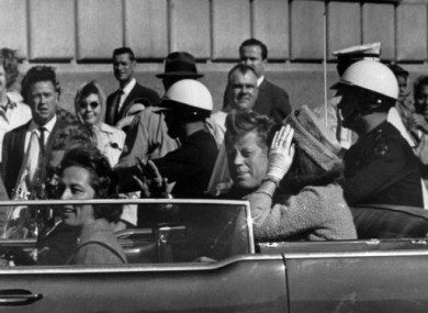 Kennedy rides in a motorcade with his wife Jacqueline, right, Nellie Connally, left, and her husband, Gov. John Connally of Texas