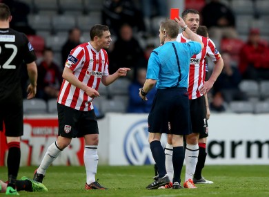 Referee Anthony Buttimer red card's Rory Patterson of Derry as Danny Ventre (l) complains.