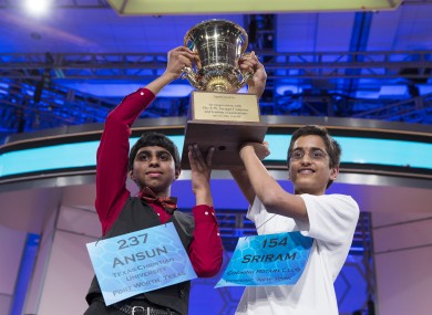 Ansun Sujoe, 13, of Fort Worth, Texas, left, and Sriram Hathwar, 14, of Painted Post, N.Y., raise the championship trophy after being named co-champions of the National Spelling Bee.