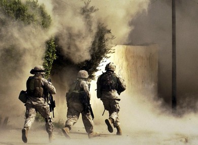 US Marines run to a building after detonating explosives. (File photo, 2004)