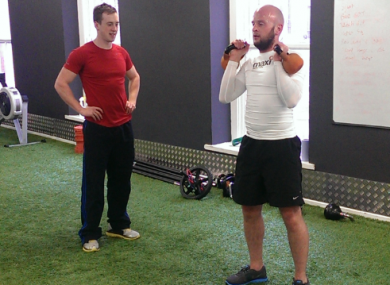 Ben tries out kettlebells with Ronan watching on.