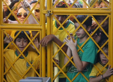 Brazilian supporters gather outside the team's training ground.