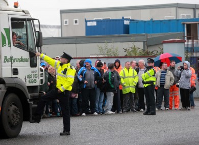 Gardai redirect trucks bound for Greyhound Recycling away from its entrance, which is blocked by supporters of the striking workers on Crag Avenue in Clondalkin this morning.