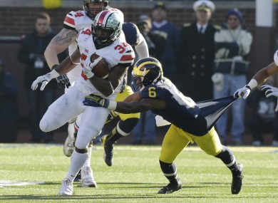 Ohio State running back Carlos Hyde (34) is tackled by Michigan defensive back Raymon Taylor.
