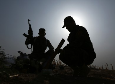Pictured here earlier thsi month, Iraqi Kurdish soldiers pause from combat to make tea near to the front line in Mahmoudiyah, Iraq, a day after they take control of the village from the Islamic State group.