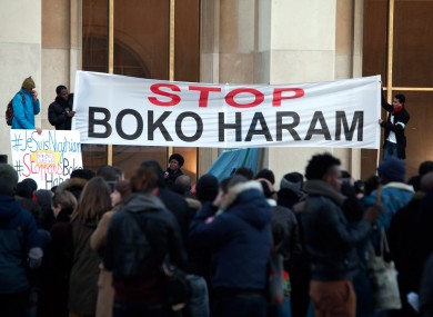 Men hold a banner during a gathering at the Trocadero place in Paris to protest against extremist Islamic group Boko Haram.