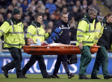 Burnley's Kevin Long is taken off injured during the Barclays Premier League match at St James' Park.