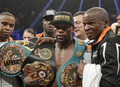 Floyd Mayweather Jr, left, poses with his champion's belt at the weekend.