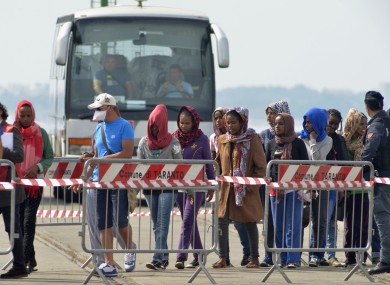 Rescued migrants line up after disembarking from the Irish Navy ship LÉ Eithne in Taranto, Italy, earlier this month.