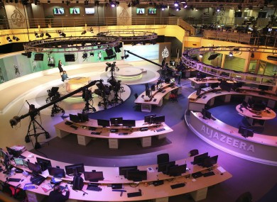 Staff members of Al-Jazeera International work at the news studio in Doha, Qatar