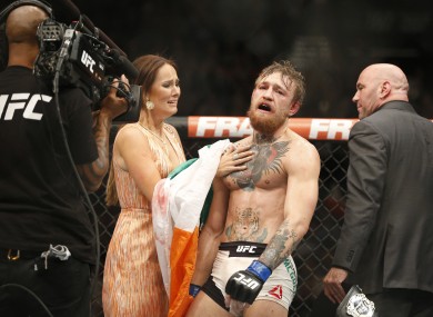 An emotional Conor McGregor with girlfriend Dee Devlin in the aftermath of his interim featherweight title win at UFC 189.