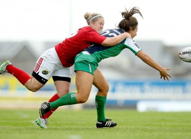 Sene Naoupu of Connacht gets a pass off as she's tackled by Nicola Scully.