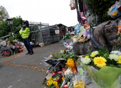 Flowers outside the gates of the halting site where the fire took place, last week.