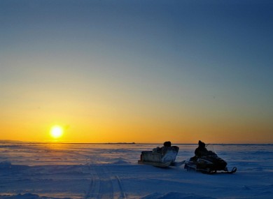 File photo: Inuit hunters drive across Frobisher Bay in front of the arctic horizon