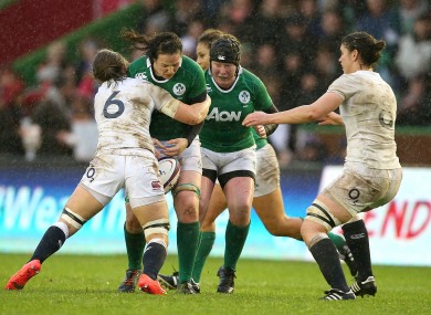 Paula Fitzpatrick is tackled by England's Hannah Gallagher.