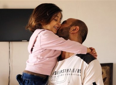 Abdul Halim al-Attar kisses his daughter Reem, 4, at their house in Beirut.