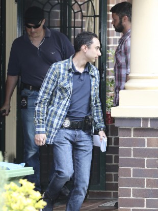 Federal police officers leave the Sydney property.